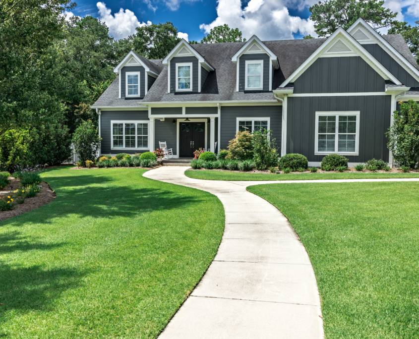 new house with a landscaped yard and a long leading walkway