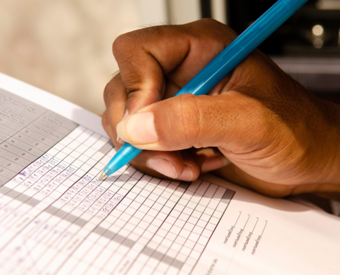 Close up of a person filling out service report